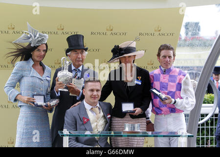 Thomas Chippendale ridden by Johnny Murtagh (R) with owners Sir and Lady Robert Ogden and Lady Cecil (second right) presented by David Weir (centre) after winning the Hardwicke Stakes during day five of the Royal Ascot meeting at Ascot Racecourse, Berkshire. Stock Photo