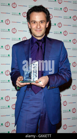 Composer Peter Juylian poses with the award for Best British director on behalf of Christopher Nolan during the 23rd Awards of the London Film Critic's Circle at the Dorchester in London's Park Lane. Stock Photo