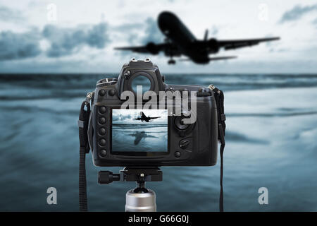 Camera photography top on blurred sea sunset and airplane background, Photograph, Photographer Stock Photo