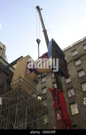 Damien Hirst's 'Hymn' is lifted into The Saatchi Galley on the South Bank in south London. The gallery, owned by Charles Saatchi and due to open in mid-April, * ... is located inside County Hall and will house works by contemporary British artists such as Hirst, Tracey Emin and Sarah Lucas. Charles Saatchi paid 1 million for Hirst's 'Hymn'. Stock Photo