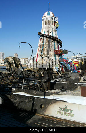 The charred remains of the ghost train ride and the helter skelter on Brighton Pier in West Sussex following a fire on the structure. Stock Photo