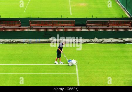 Tennis - 2013 Wimbledon Championships - Day One - The All England Lawn Tennis and Croquet Club. Lines are painted during day one of the Wimbledon Championships at The All England Lawn Tennis and Croquet Club, Wimbledon. Stock Photo