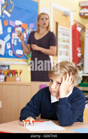 Male Elementary School Pupil Struggling In Class Stock Photo - Alamy