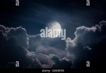 Attractive photo of a nighttime sky with clouds, bright full moon would make a great background. Nightly sky with large moon. Stock Photo