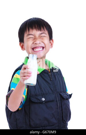 Close up. Fun portrait of handsome asian boy smiling and holding bottle of milk. Drinking milk for good health. Stock Photo