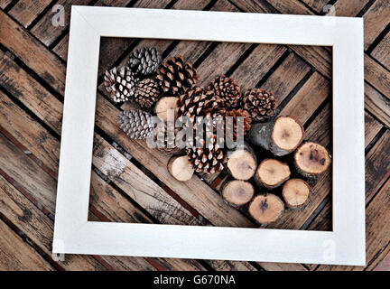 white frame with dried pineapple and cut timber on a table Stock Photo