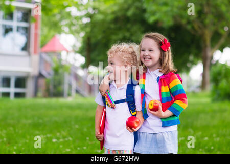 Child going to school. Boy and girl holding books and pencils on first school day. Little students excited to be back to school Stock Photo