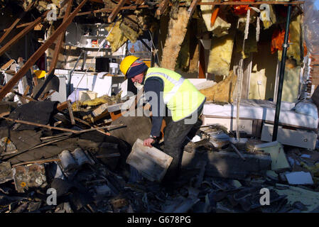 A council worker clears up after a gas explosion at a house in Bocking, near Braintree, Essex. A 55-year-old man was taken to hospital after the explosion ripped through his bungalow. * He was rescued from his kitchen by a passer-by, said a spokesman for Essex County Fire and Rescue Service. Stock Photo
