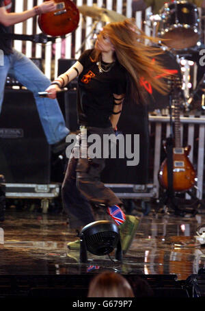 Canadian singer Avril Lavigne performing on stage during The Brit Awards 2003 at Earls Court 2, London. Stock Photo