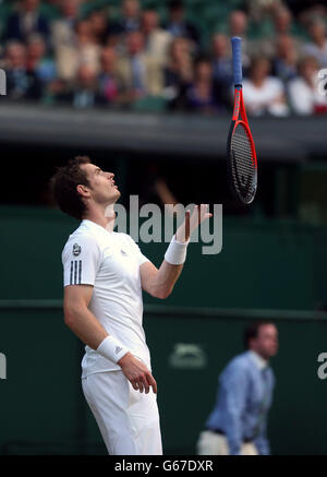 Great Britain's Andy Murray shows his frustration and tosses his racquet up in the air during his match against Poland's Jerzy Janowicz during day eleven of the Wimbledon Championships at The All England Lawn Tennis and Croquet Club, Wimbledon. Stock Photo