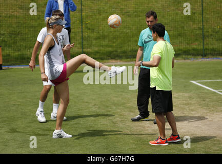 Tennis - 2013 Wimbledon Championships - Day Two - The All England Lawn Tennis and Croquet Club. Russia's Maria Sharapova plays football during a practice session Stock Photo