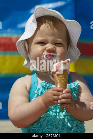 12 month old Rose Blythe enjoys an ice cream on West Wittering beach near Chichester, West Sussex. Stock Photo