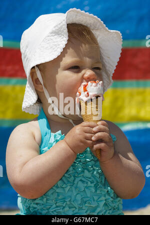 12 month old Rose Blythe enjoys an ice cream on West Wittering beach near Chichester, West Sussex. Stock Photo