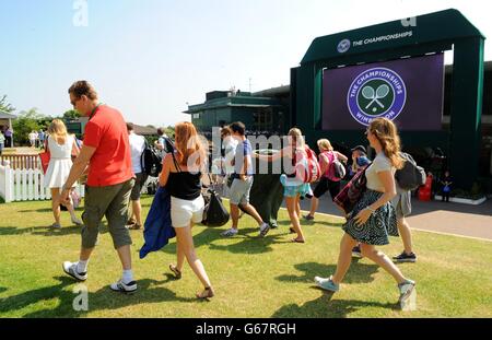 Fans run to take their places on Murray Mount during day thirteen of the Wimbledon Championships at The All England Lawn Tennis and Croquet Club, Wimbledon. Stock Photo