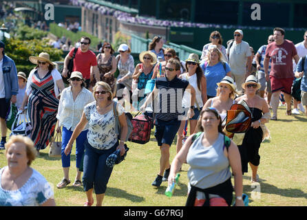 Fans run to take their places on Murray Mount during day thirteen of the Wimbledon Championships at The All England Lawn Tennis and Croquet Club, Wimbledon. Stock Photo