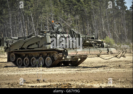 A Terrier armoured digger in the mine clearance role, which is entirely controlled remotely during an unveilling at the Defence Armoured Vehicle Centre, Bovington, Dorset. Stock Photo