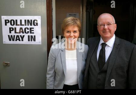 First Minister Nicola Sturgeon and with her husband Peter Murrell arrive to cast their votes at Broomhoouse Community Hall, Glasgow, as voters head to the polls across the UK in a historic referendum on whether the UK should remain a member of the European Union or leave. Stock Photo