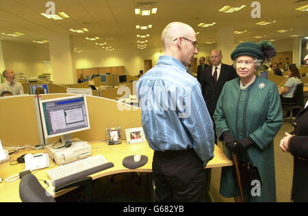 Britain's Queen Elizabeth II chats to customer service advisor Billy McGee from Belfast at the Halifax Bank of Scotland call centre at Cromac Wood, south of the city. * On the final engagement of their one-day trip to Northern Ireland, the Queen and the Duke of Edinburgh were accompanied around the 45 million waterside building which opened in June 2001, by Northern Ireland Secretary Paul Murphy and enterprise minister Ian Pearson. Stock Photo