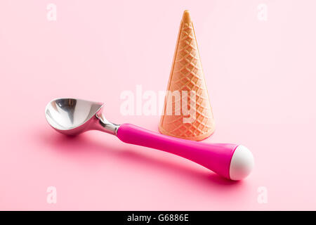 wafer cone and ice cream scoop on pink background Stock Photo
