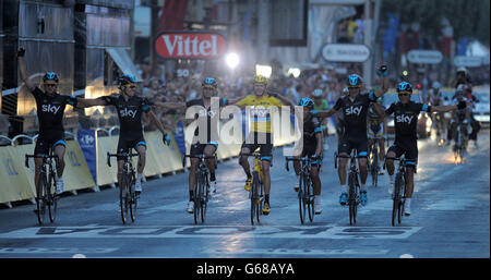 Team Sky's Chris Froome of Great Britain (centre) celebrates with team mates as he crosses the line to win the 2013 Tour de France in Paris, France. Stock Photo
