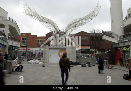 A sculpture labelled the 'Angel of the South' waits to be unveiled in a shopping centre in Islington, north London. The 52ft high model was designed by sculptor Wolfgang Butress, who won a competition to design the piece and will tower over the central park. Stock Photo