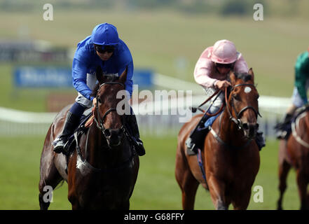 Urban Dance ridden by Mickael Barzalona (left) wins the Celebrating Newmarket - Historic Home of Horse Racing Maiden Stakes during Abu Dhabi Gentlemen's Day of the Piper-Heidsieck July Festival at Newmarket Racecourse, Newmarket. Stock Photo