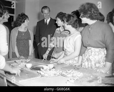 Prince Philip, The Duke of Edinburg looks in on a cookery class in the girl's club during his visit to the Brady youth clubs in Hanbury Street, Stepney, London. The Duke, who is Patron of the London Federation of Boy's Clubs, watched many of the activities during his tour of the boys' and girls' clubs. Stock Photo