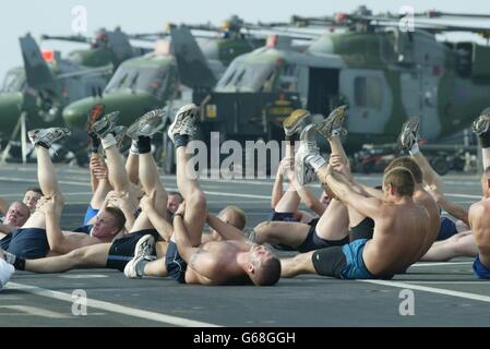Royal Marines go through their fitness routine on the deck of HMS Ocean as it travels thorugh the Persian Gulf. Stock Photo