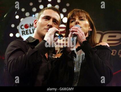 Celebrity students actor Will Mellor and comedienne Doon Mackichan performing on stage singing for survival during rehearsal at the Comic Relief does Fame Academy in north London. Stock Photo