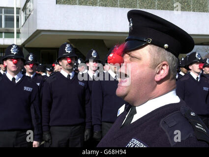 Drill instuctor Peter Clements from Stevenage in charge of police recruits wearing red noses in a rehearsal for their passing out parade on Friday March 14 2003 at Hendon Training School, North London. *..The new recruits have undertaken a range of activities to raise more than 7,000 for a local charity, North London Hospice. Charity events included a sponsered diet and a Cadbury's Creme Egg Eat-a-thon. Stock Photo