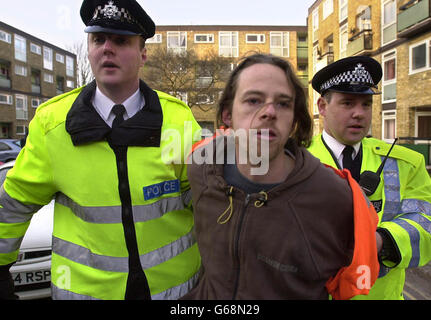 A man is led away by police during a demonstration opposed to war with Iraq outside the south London home of Foreign Secretary Jack Straw. Up to 40 protesters shouted slogans and waved banners as Mr Straw left his house. One person attempted to chain himself to railings. Stock Photo