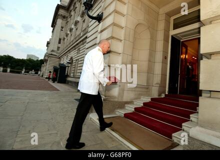The Queen's senior Page Philip Rhodes carries the official notification into Buckingham Palace, that announces the birth of a baby boy at 4.24 pm to the Duke and Duchess of Cambridge at St Mary's Hospital in west London. Stock Photo