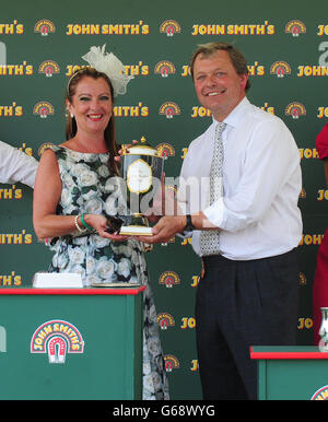 Trainer of Danchai, William Haggas, receives the trophy after winning the 54th John Smith's Cup during the 2013 John Smith's Cup Meeting at York Racecourse, York. Stock Photo