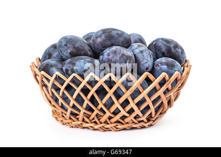 Fresh ripe organic plums in woven basket isolated on a white Stock Photo