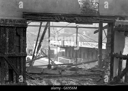 The smoke still rises from the charred remains of the main stand at the Valley Parade football ground, after the blaze which left over 50 dead and more than 200 injured was brought under control. The fire swept the packed stand just before half-time as Division Three Champions Bradford City played Lincoln City in the last game of the season. Stock Photo