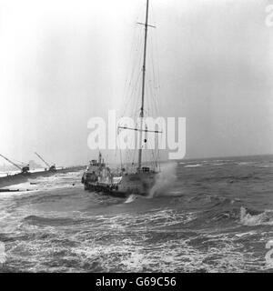 A wave crashing against the bows of the pirate music station, Radio Caroline, aground in rough waters between Frinton and Holland-on-Sea, where she blown by gale-force winds during the night. Five disc jockeys taken off by breeches buoy were among those rescued from vessel earlier in the day. Stock Photo