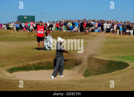 USA's Tiger Woods chips out of the bunker on the 15th hole during day three of the 2013 Open Championship at Muirfield Golf Club, East Lothian. Stock Photo