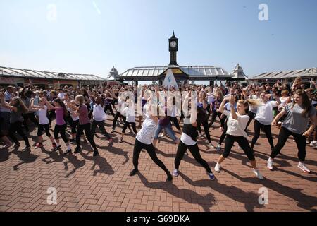 s Teen Beach Movie flash mob. s Teen Beach Movie on Brighton Pier in east Sussex. Stock Photo