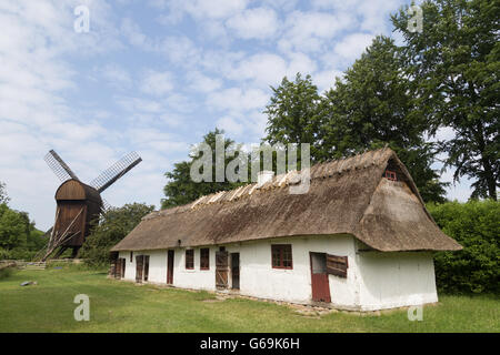 Lyngby, Denmark - June 23, 2016: Ancient danish farmhouse and windmill in Frilandsmuseet. Stock Photo