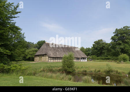 Lyngby, Denmark - June 23, 2016: An ancient danish half-timbered farmhouse with straw roof. Stock Photo