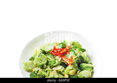 Thai food stir fried broccoli in plate called Pad Pak isolated on white Stock Photo