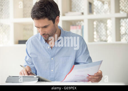 Man using online banking to manage personal finances Stock Photo