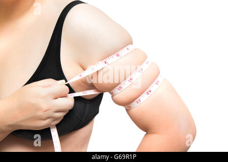 Woman show and squeeze tighten arm body fat by measure tape or line tape overweight plastic surgery concept on white isolated Stock Photo