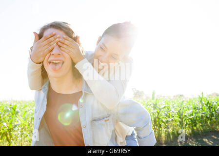 Man giving girlfriend piggyback ride Stock Photo