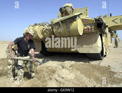 2nd Royal Tank Regiment (Desert Rats) dig in for the night at AZ Zubaya, near Basra, Iraq. The trench gives some protection in case of attack. Stock Photo