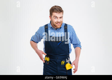 Funny male builder looking at camera isolated on a whtie background Stock Photo