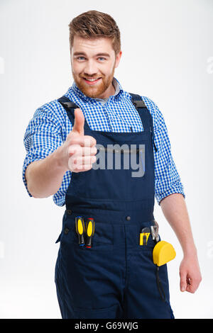 Happy male builder showing thumb up isolated on a white background Stock Photo
