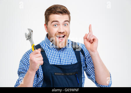 Smiling male builder showing finger up isolated on a white background. I having idea Stock Photo