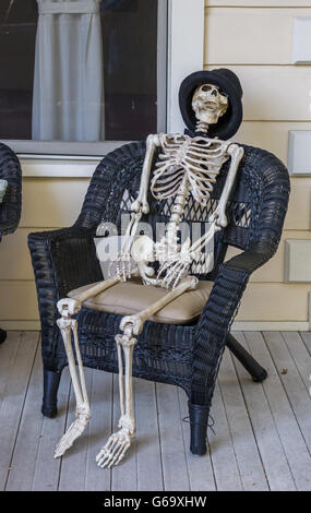 American porch in halloween style with a skeleton sitting in a chair Stock Photo