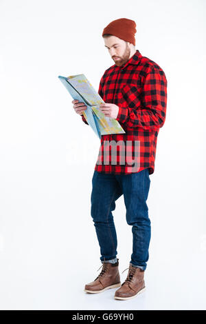 Serious young bearded man holding map isolated on the white background Stock Photo